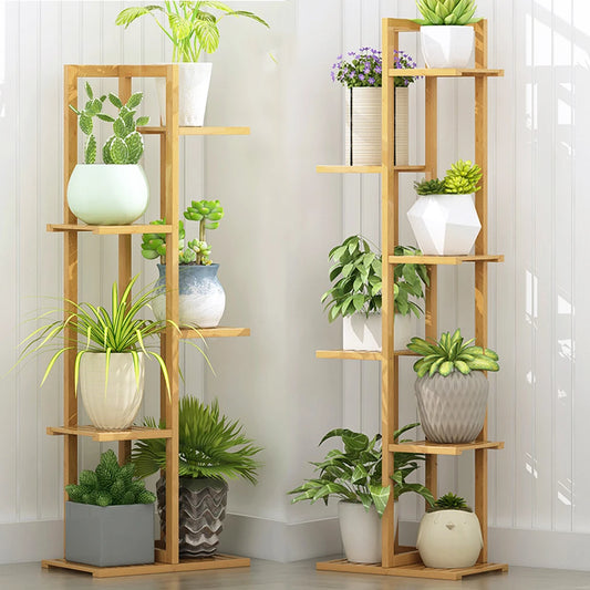 Wooden plant shelves with potted plants against a white wall.