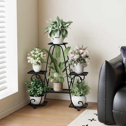 Decorative plant stand with potted plants and flowers in a living room setting.